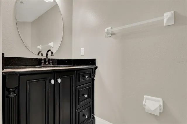 a close view of a sink a vanity and mirror in bathtub