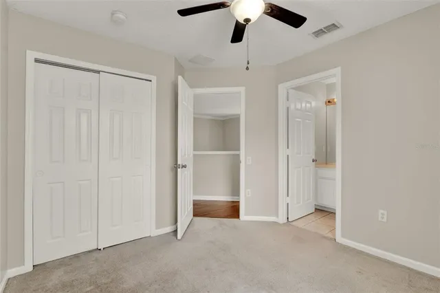 an empty room with chandelier fan