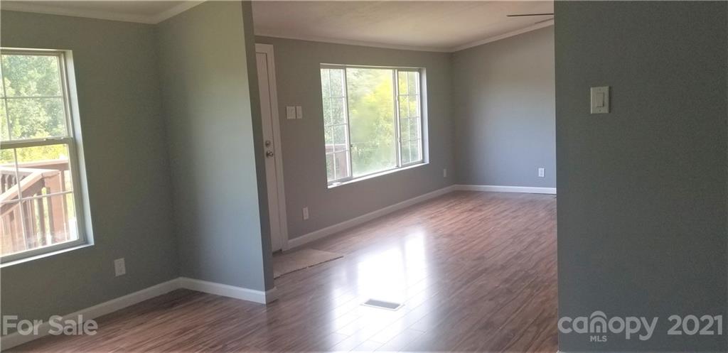 4880 Crystal Creek Road Morganton, NC 28655 - Photo 17 of 26 a view of an empty room with wooden floor and a window