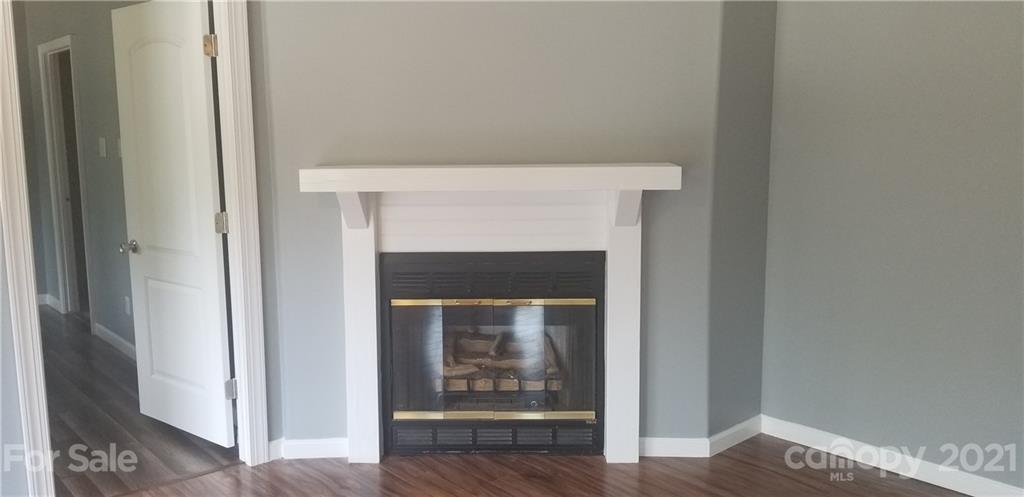 4880 Crystal Creek Road Morganton, NC 28655 - Photo 19 of 26 a view of an empty room with wooden floor and a fireplace