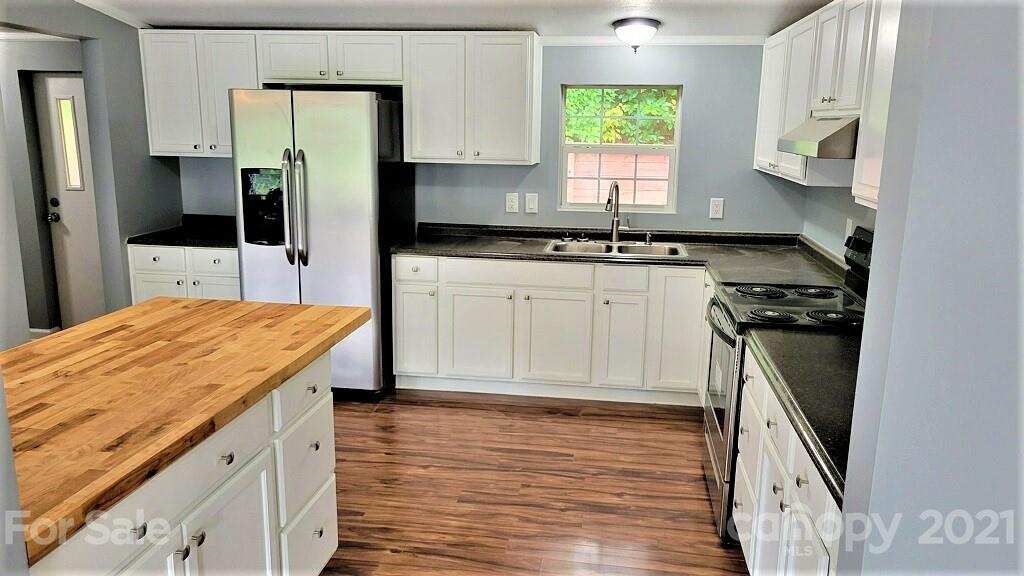 4880 Crystal Creek Road Morganton, NC 28655 - Photo 3 of 26 a kitchen with a sink appliances cabinets and a window