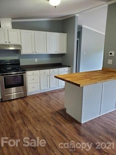 4880 Crystal Creek Road Morganton, NC 28655 - Photo 4 of 26 a kitchen with granite countertop wooden cabinets and a stove