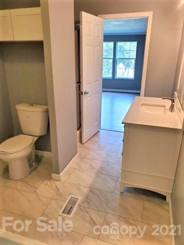 4880 Crystal Creek Road Morganton, NC 28655 - Photo 7 of 26 a bathroom with a sink toilet and window