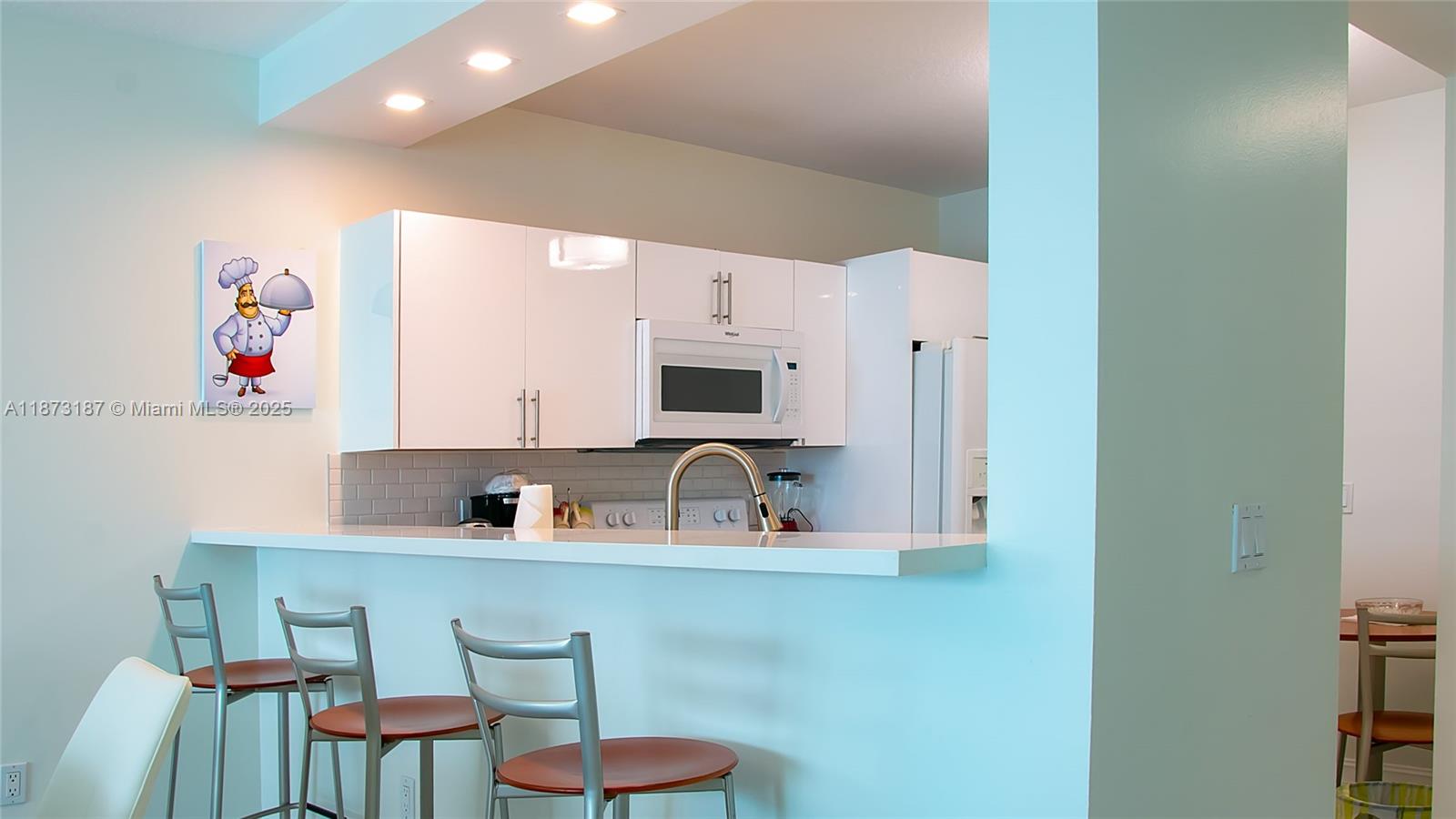 18100 North Bay Road, Unit 906 Sunny Isles Beach, FL 33160 - Photo 11 of 21 a kitchen with a sink cabinets and window