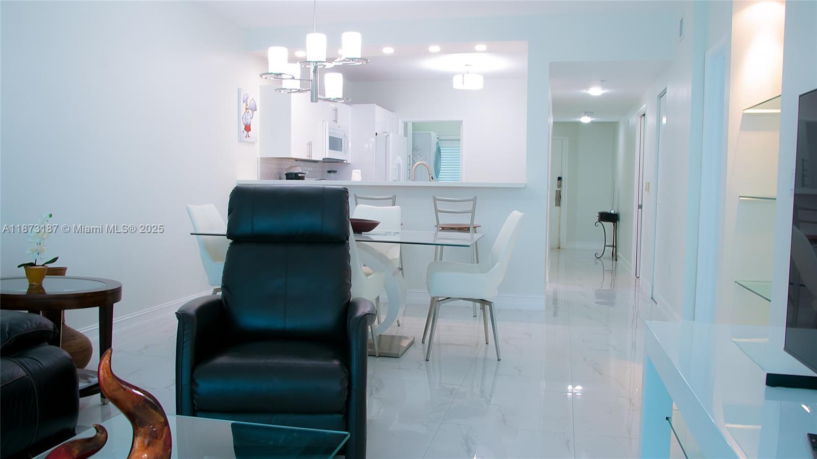 18100 North Bay Road, Unit 906 Sunny Isles Beach, FL 33160 - Photo 15 of 21 a kitchen with kitchen island a breakfast area