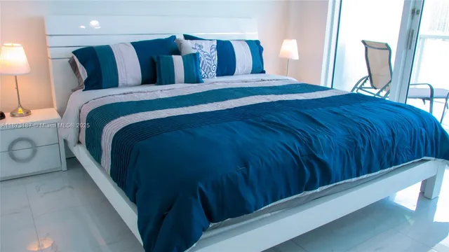 a bed sitting in a bedroom next to a window