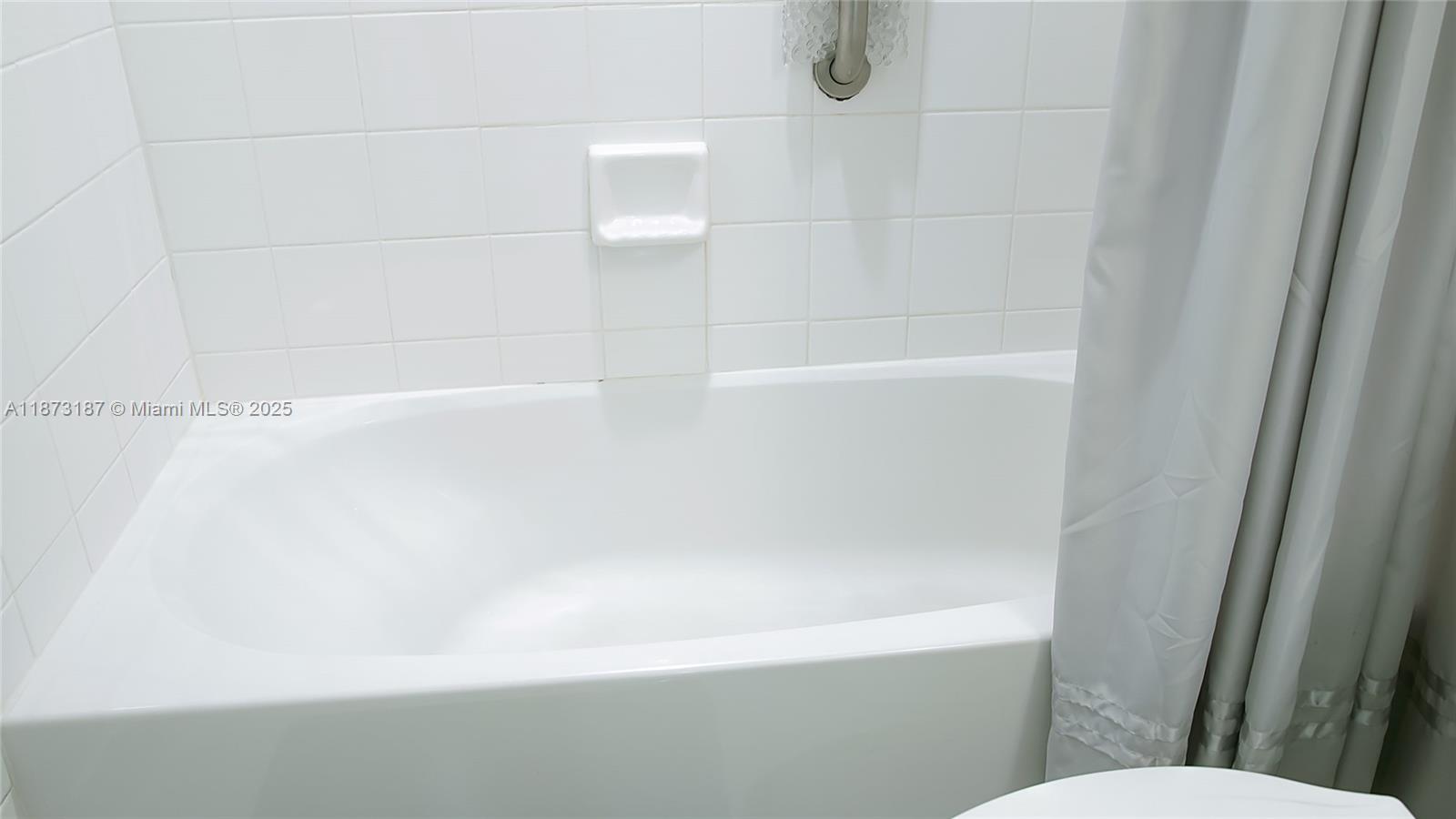 18100 North Bay Road, Unit 906 Sunny Isles Beach, FL 33160 - Photo 3 of 21 a bathroom with a shower and a toilet