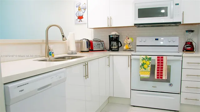 a kitchen with sink and cabinets
