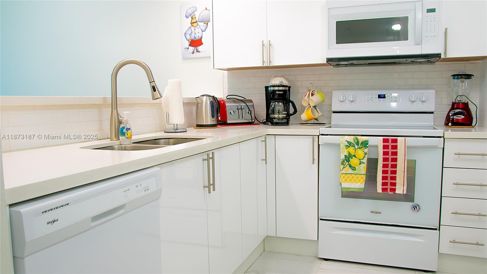 18100 North Bay Road, Unit 906 Sunny Isles Beach, FL 33160 - Photo 10 of 21 a kitchen with sink and cabinets