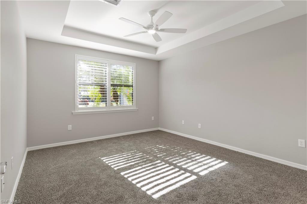 6068 Triumph Lane Ave Maria, FL 34142 - Photo 16 of 27 an empty room with windows and fan