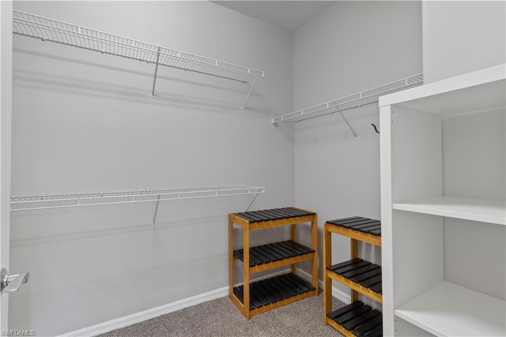 6068 Triumph Lane Ave Maria, FL 34142 - Photo 20 of 27 a view of room with racks on the wall