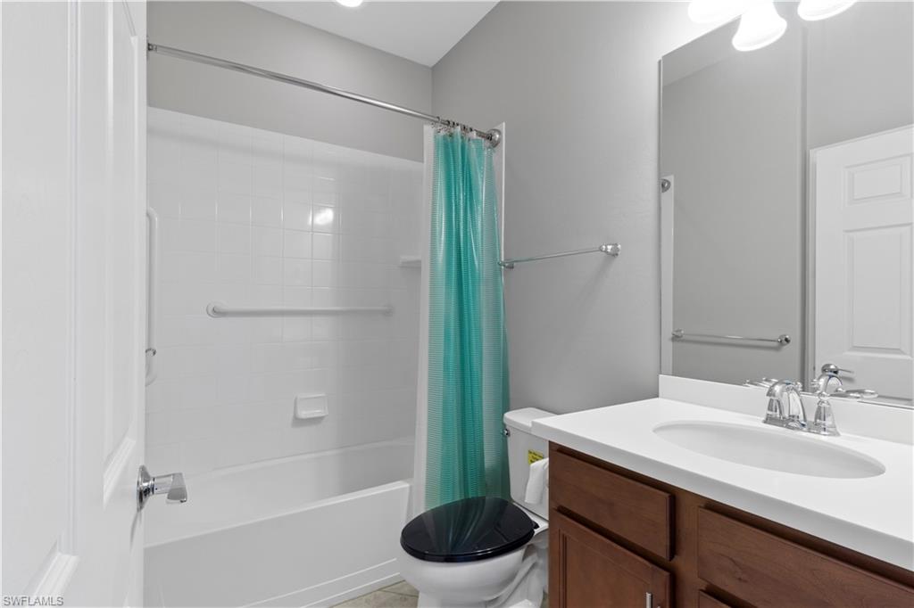 6068 Triumph Lane Ave Maria, FL 34142 - Photo 8 of 27 a bathroom with a sink toilet and shower