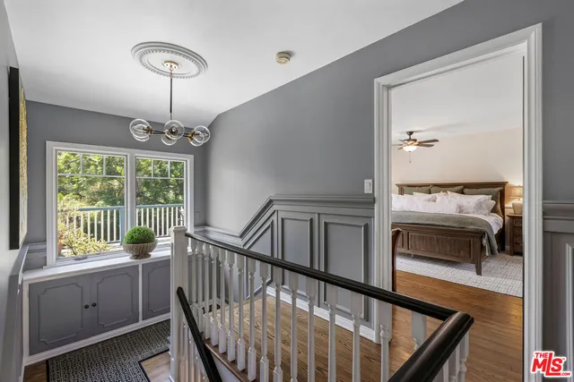 a view of a hallway with furniture and windows