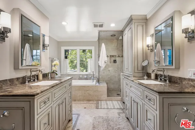 a spacious bathroom with a granite countertop sink mirror and a bathtub