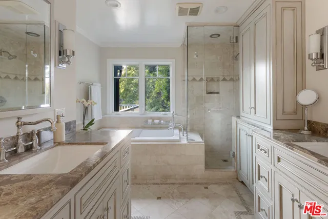 a bathroom with a granite countertop sink mirror and a bathtub