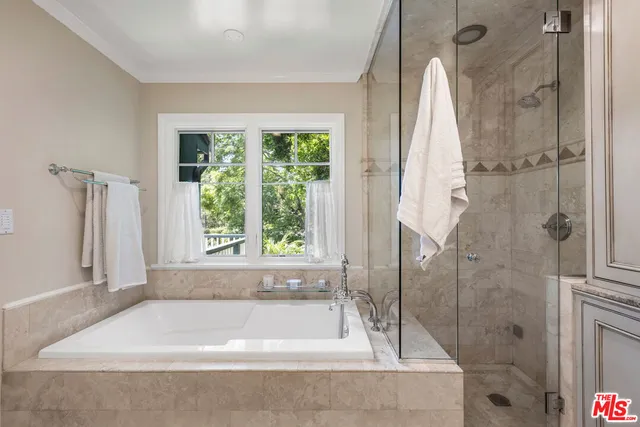 a bath tub sitting in a bathroom next to a window