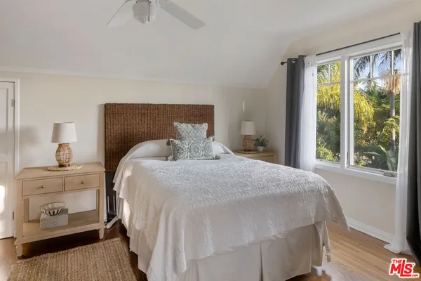 a bedroom with a bed and a night stand