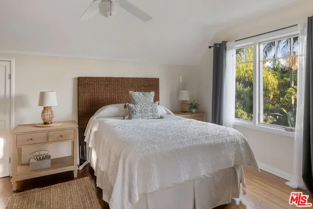 a bedroom with a bed and a night stand