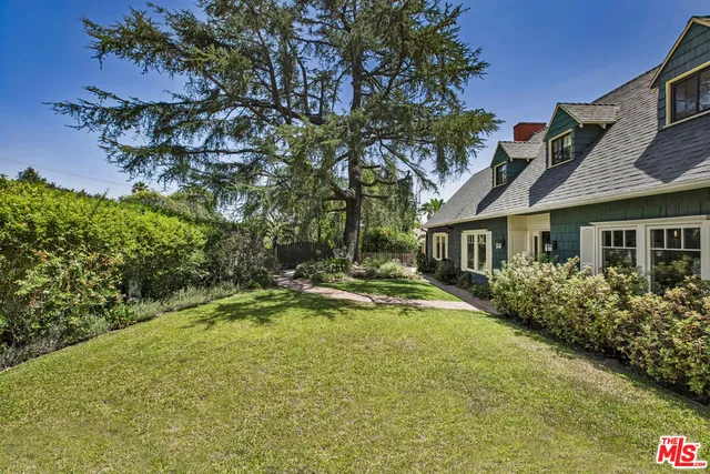 a view of house with outdoor space and swimming pool