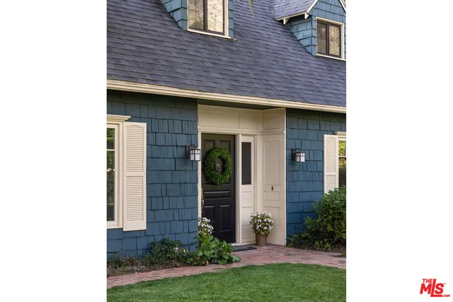 a view of a brick house with a large windows