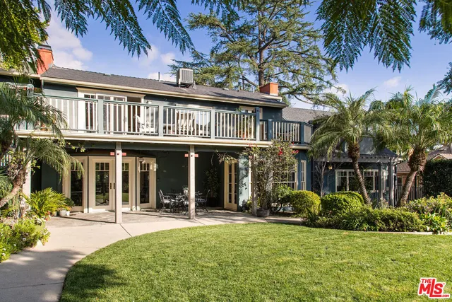 a view of a house with swimming pool and sitting area