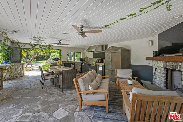 a living room with furniture a fireplace and a chandelier