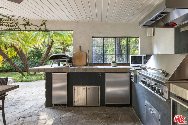 a kitchen with a stove a sink and a refrigerator