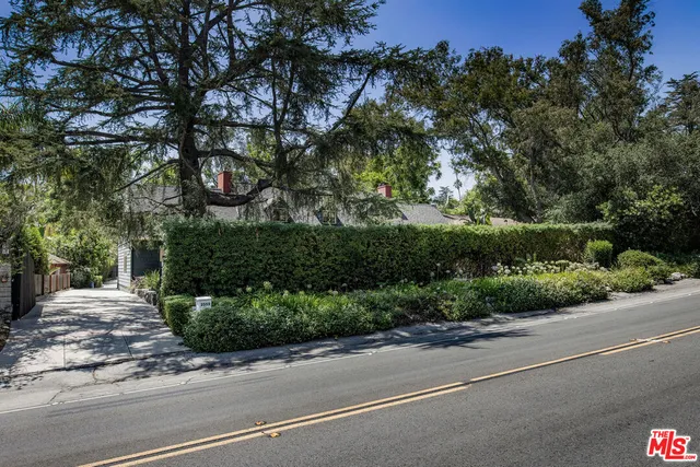a street view with sitting space and trees