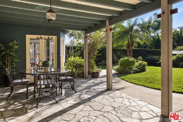 a view of a porch with chairs and backyard