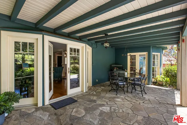 a view of a porch with chairs and table in patio