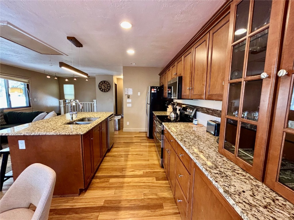 1310 Baldy Road, Unit D Breckenridge, CO 80424 - Photo 11 of 28 a large kitchen with stainless steel appliances kitchen island granite countertop a large counter top and stove
