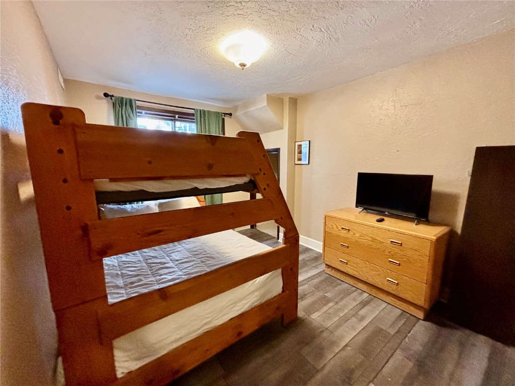 1310 Baldy Road, Unit D Breckenridge, CO 80424 - Photo 19 of 28 a bedroom with a bed and flat screen tv