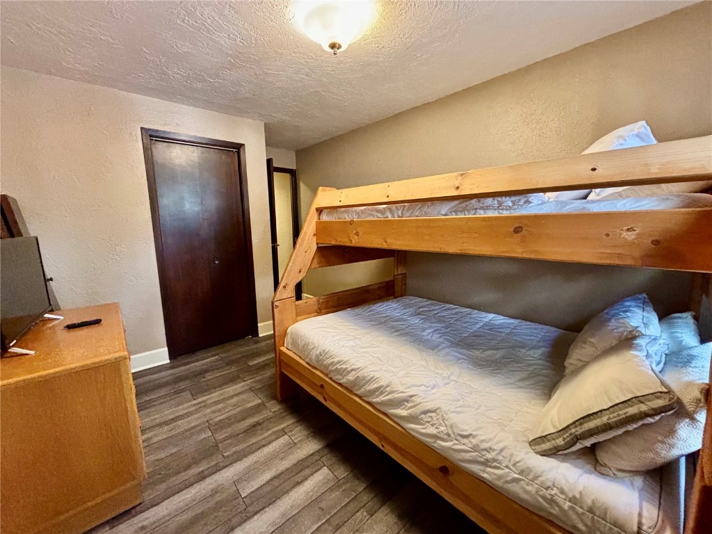 1310 Baldy Road, Unit D Breckenridge, CO 80424 - Photo 20 of 28 a bedroom with a bed and wooden floor