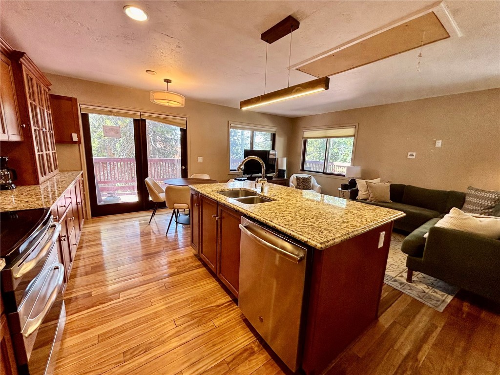 1310 Baldy Road, Unit D Breckenridge, CO 80424 - Photo 5 of 28 a kitchen with granite countertop kitchen island wooden floors and a view of living room