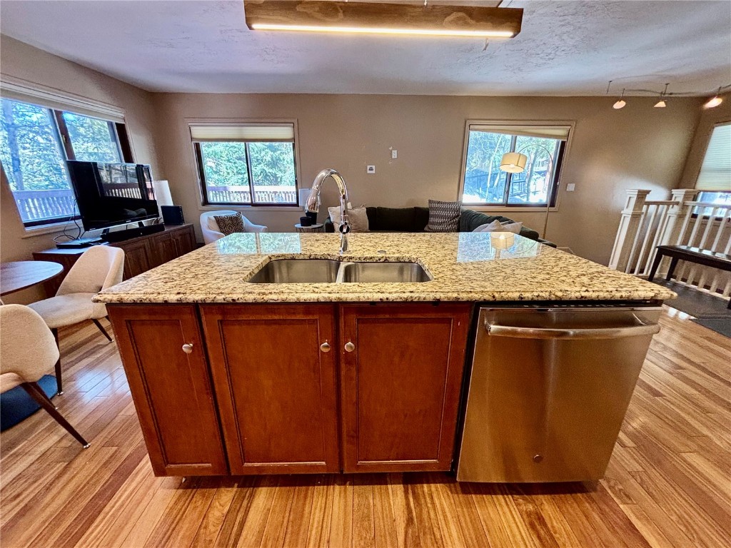 1310 Baldy Road, Unit D Breckenridge, CO 80424 - Photo 7 of 28 a kitchen with stainless steel appliances wooden floors wooden cabinets a sink and a window