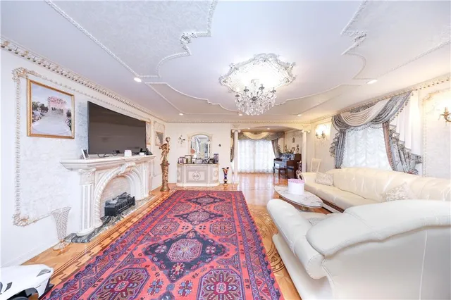 a living room with furniture and a chandelier