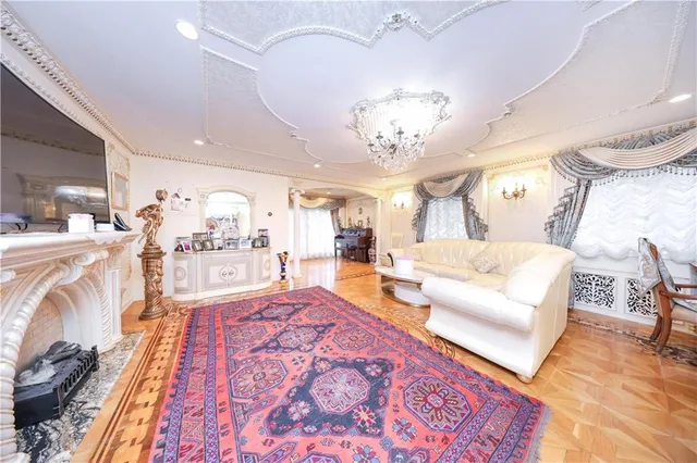 a living room with furniture and a chandelier