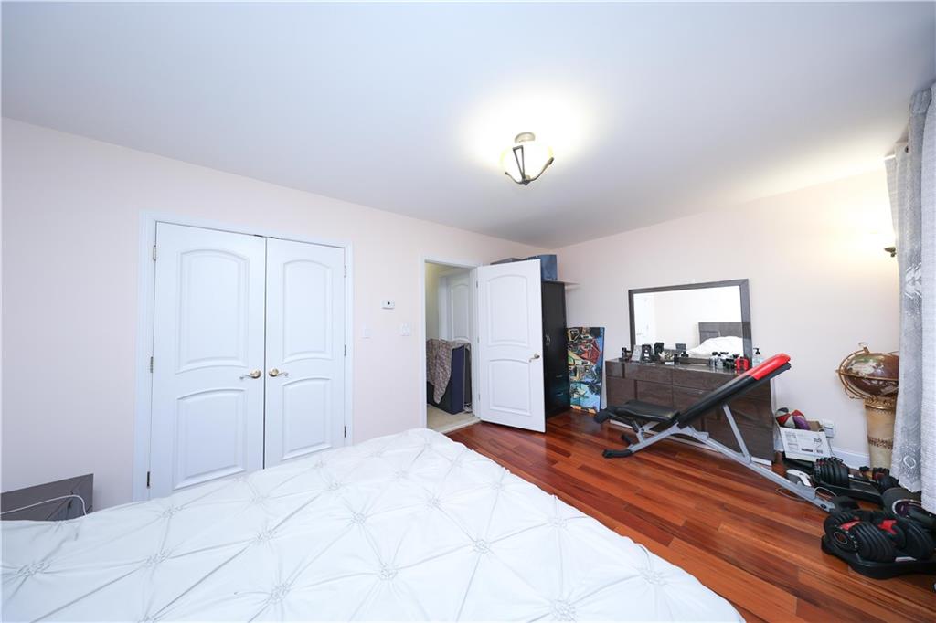 2568 East 2nd Street Brooklyn, NY 11223 - Photo 32 of 41 a room with a bed and a dresser