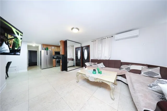 a kitchen with stainless steel appliances kitchen island granite countertop a refrigerator and stove top oven