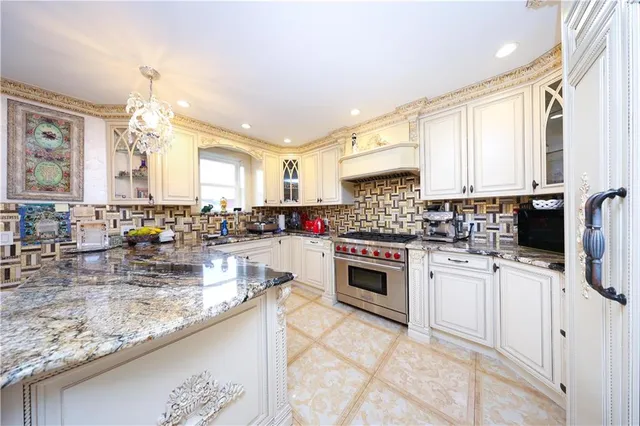 a kitchen with stainless steel appliances granite countertop a large stove a sink and dishwasher