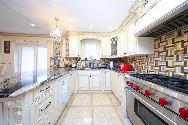 a kitchen with a refrigerator and a stove top oven