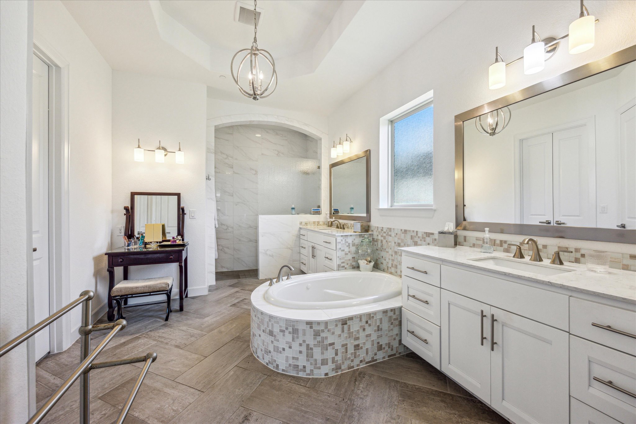 9600 Chamois Way Austin, TX 78736 - Photo 8 of 14 Full bath with two vanities, a bath, suspended lighting, walk in shower, and a raised ceiling