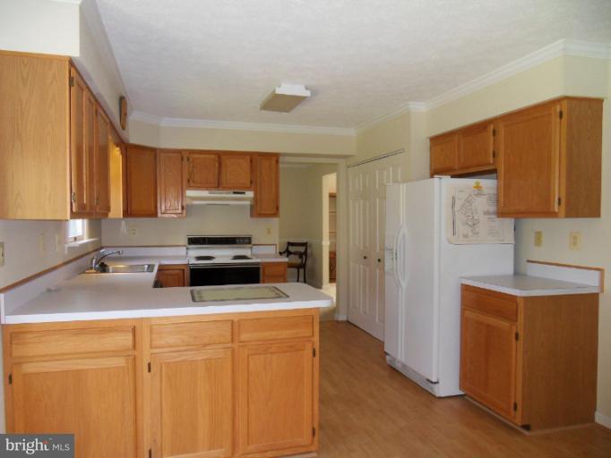 a kitchen with stainless steel appliances granite countertop a refrigerator stove microwave and sink