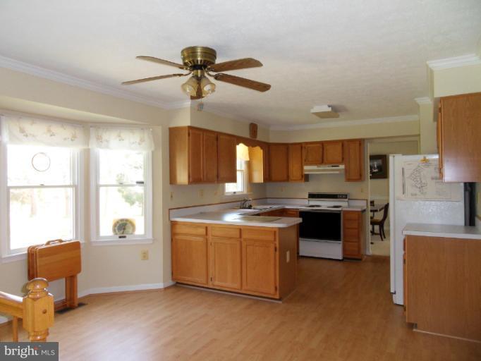 11026 George Street Lusby, MD 20657 - Photo 15 of 20 a kitchen with stainless steel appliances granite countertop a stove and a refrigerator