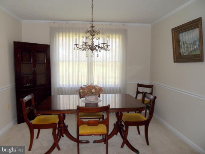 11026 George Street Lusby, MD 20657 - Photo 17 of 20 a view of a dining room with furniture and chandelier