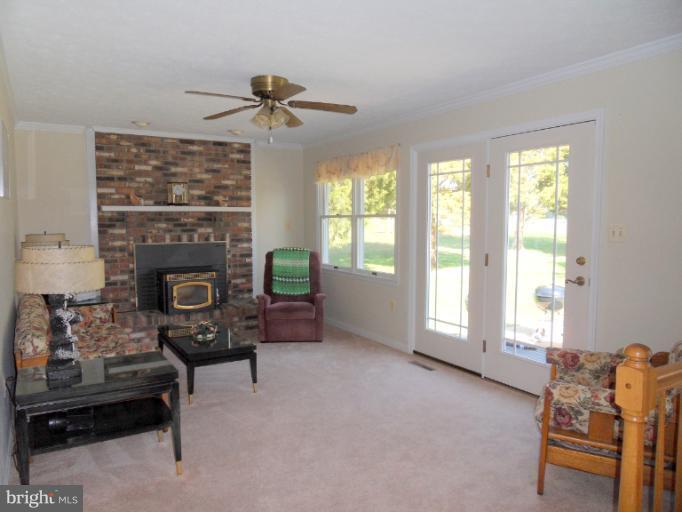11026 George Street Lusby, MD 20657 - Photo 6 of 20 a living room with furniture and a fireplace