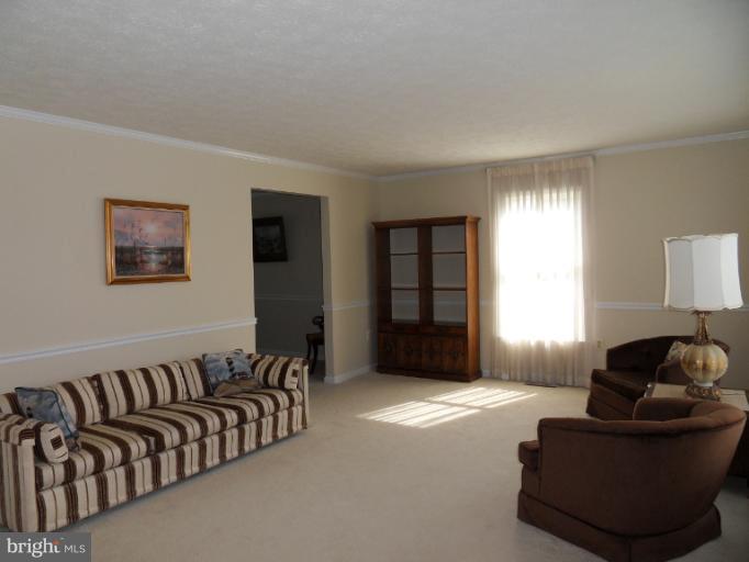 11026 George Street Lusby, MD 20657 - Photo 7 of 20 a spacious bedroom with a bed and window
