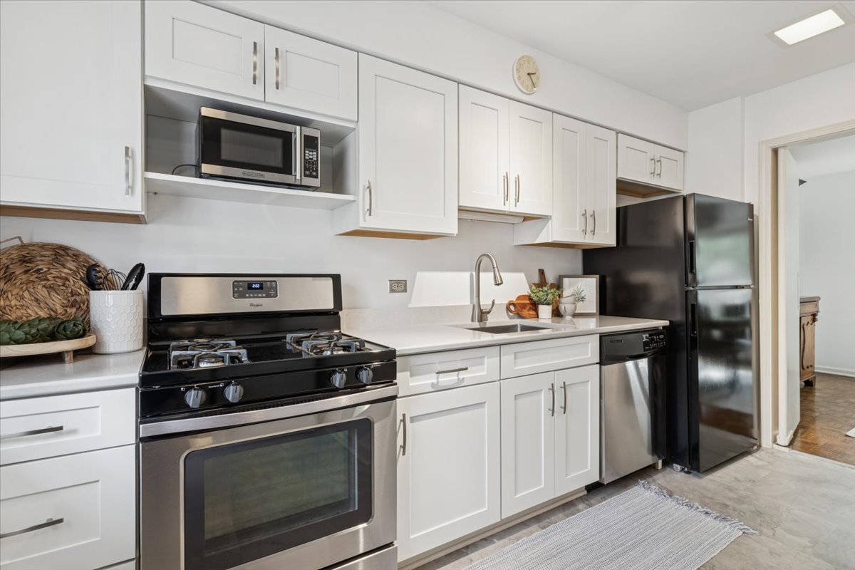 730 Oak Street Winnetka, IL 60093 - Photo 10 of 28 a kitchen with cabinets stainless steel appliances and wooden cabinets