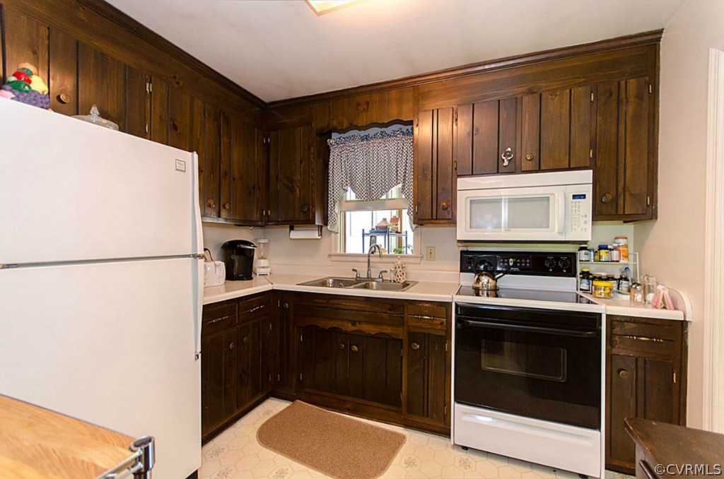 15101 Rowlett Road Chesterfield, VA 23838 - Photo 5 of 16 a kitchen with a sink stove and refrigerator