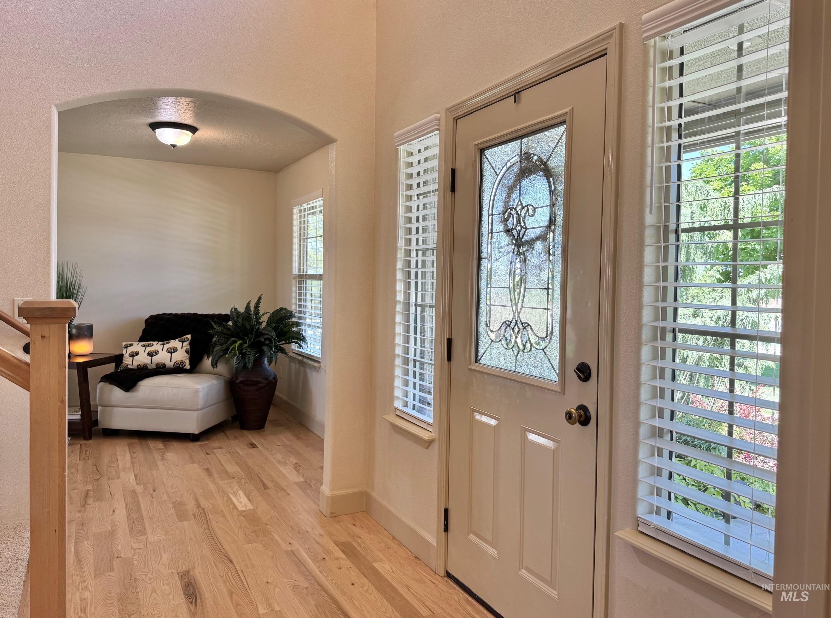 9299 Kemp Road Middleton, ID 83644 - Photo 7 of 50 Entryway featuring a decorative glass panel door and two flanking windows with blinds